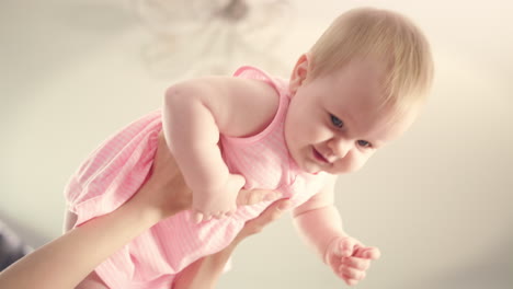 happy baby in mother hands. adorable baby laughing in mom hands