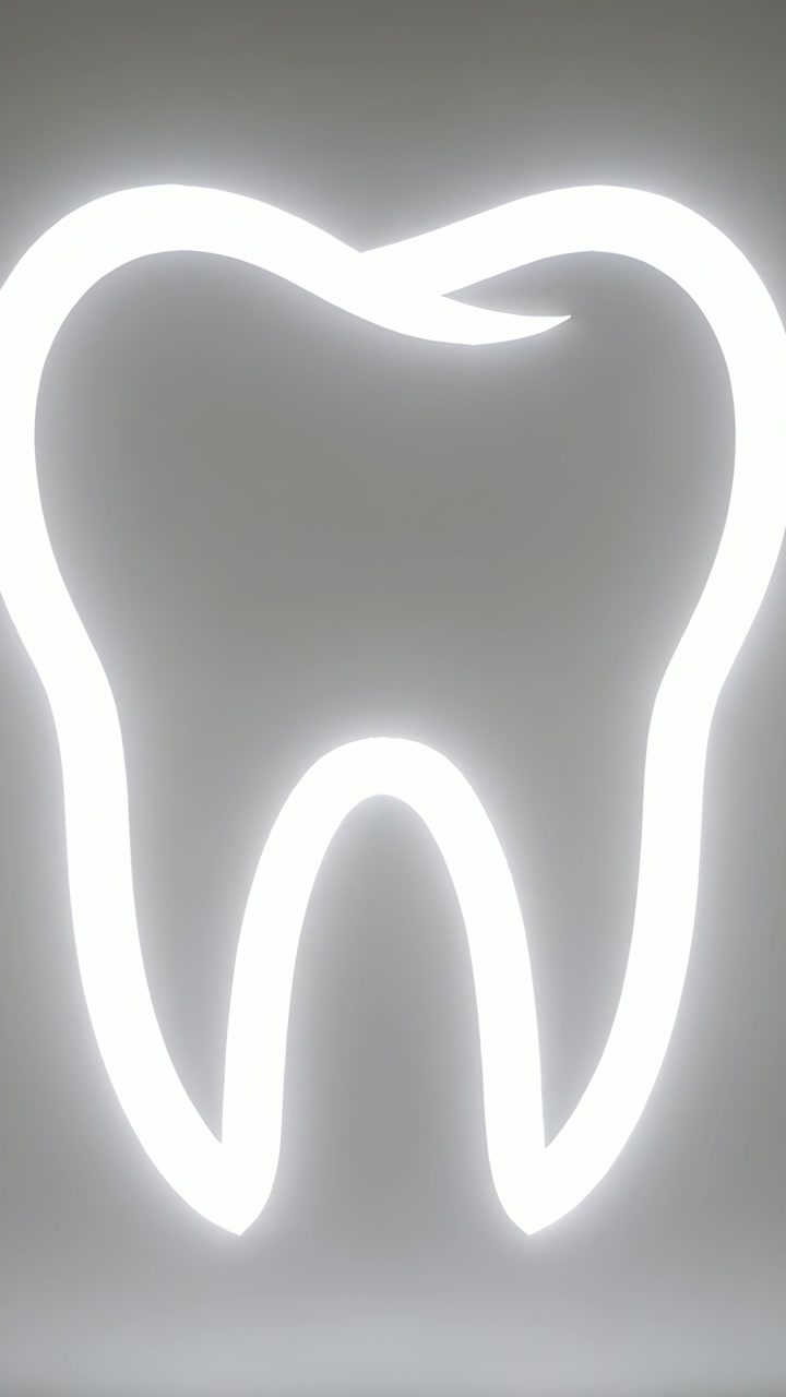Vertical video: Zooming camera tilting up in clinic, highlighting upper cusp on neon tooth halo
