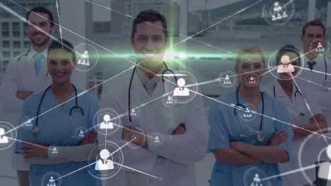 Animation-of-network-of-connections-with-icons-over-diverse-doctors