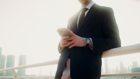 businessman using smartphone outdoors