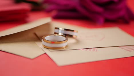 romantic gold and white rings on envelopes