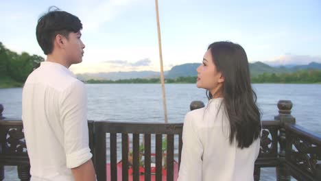 asian couple walking on the boat and looking view, video in 4k