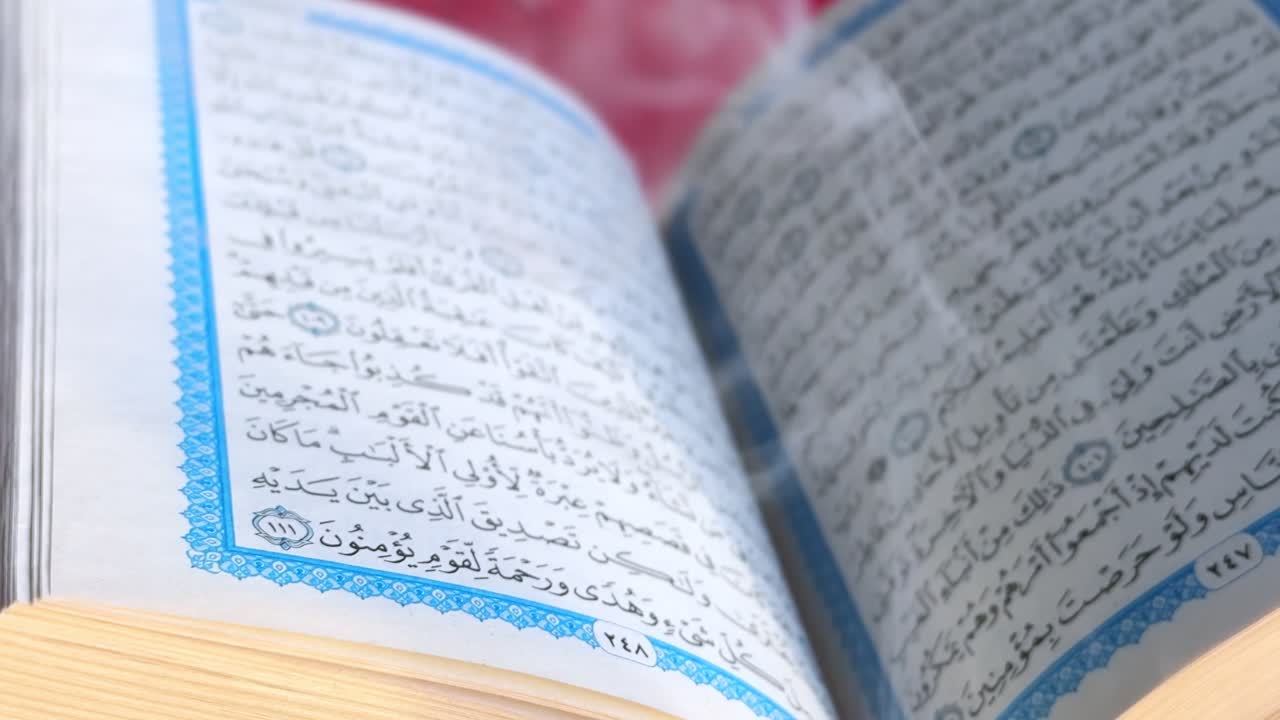High-resolution 4K close-up of an open Quran showing detailed Arabic calligraphy. Ideal for religious, spiritual, and educational content.