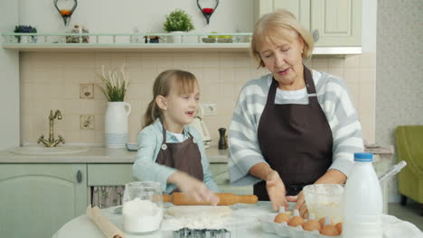 grandmother and granddaughter baking cookies