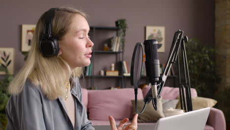 Close-Up-View-Of-Woman-Recording-A-Podcast-Wearing-Headphones