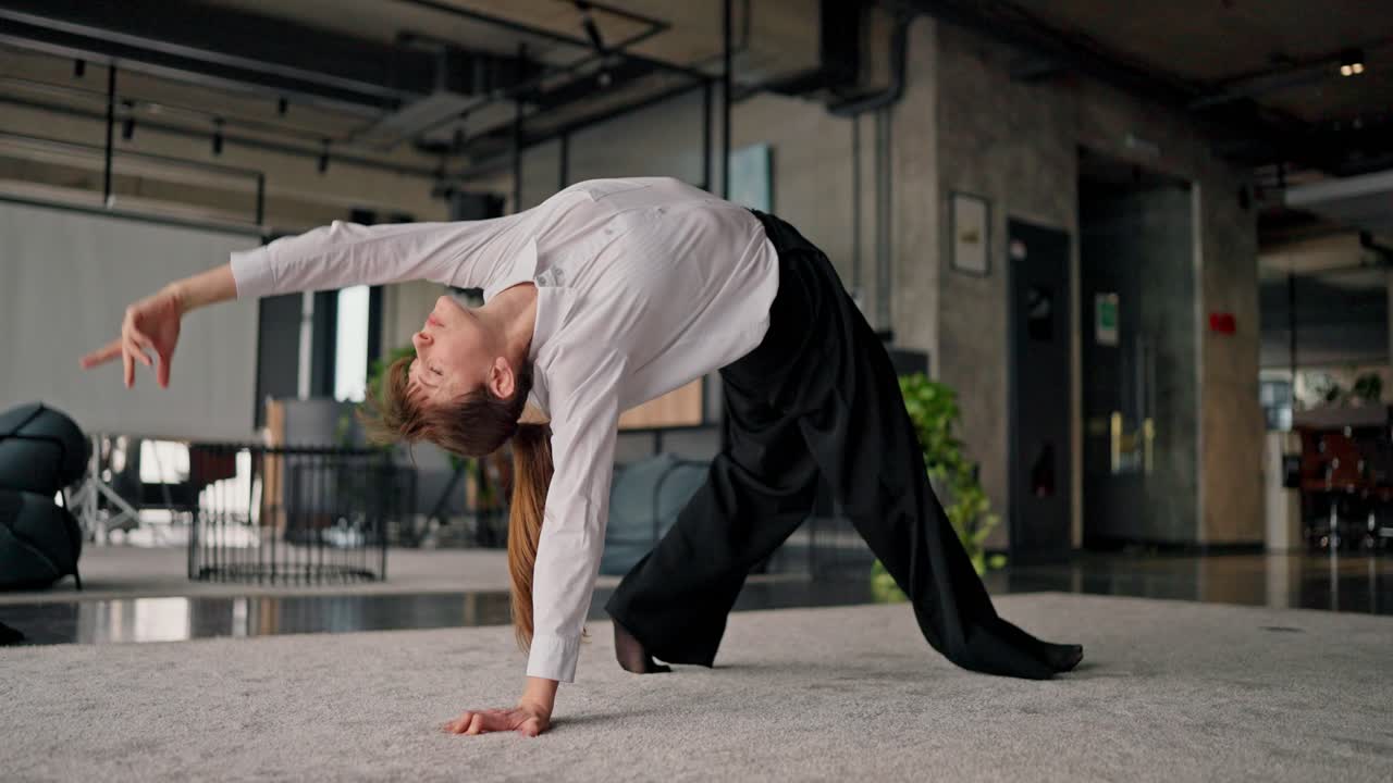 Woman practicing yoga and push-ups in an office