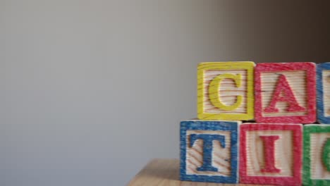 educational toy cubes with letters organised to display word caption - editing metadata and search engine optimization concept