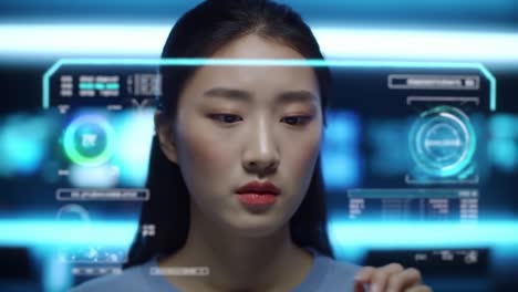 a focused female user interacts with futuristic holographic technology, engaging with digital data visualizations and graphics in a high-tech environment
