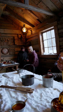 enjoying fresh maple candy on a snow table inside a rustic cabin