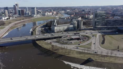 AERIAL:-Roundabout-Near-River-Neris-in-Vilnius-with-Cars-Passing-By-on-a-Sunny-Day