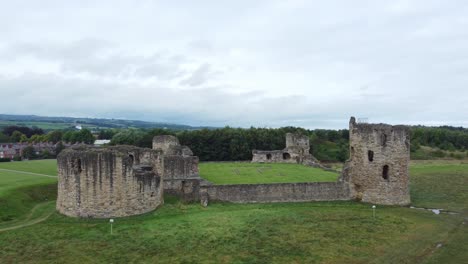 Flint-castle-Welsh-medieval-coastal-military-fortress-ruin-aerial-view-rising-orbit-right