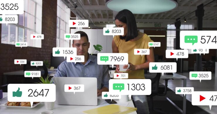 Man typing laptop triggers animating social media icons showing rising engagement metrics at desk
