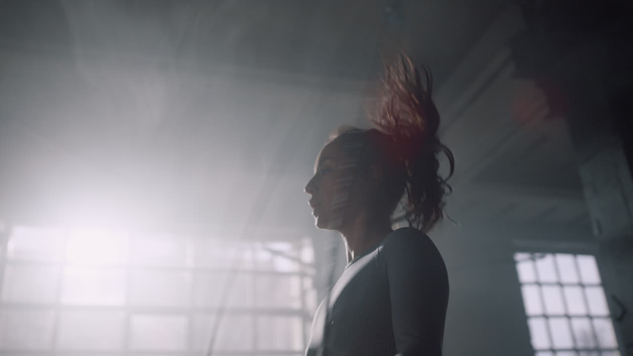 Active girl exercising on jump rope. Energetic woman jumping on skipping rope