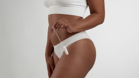 woman holding a tampon