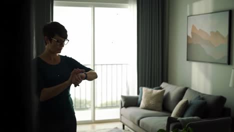 woman interacting with smart device in modern living room, showcasing technology and lifestyle integration with a calm and inviting atmosphere