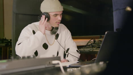 young caucasian man working at music recording studio