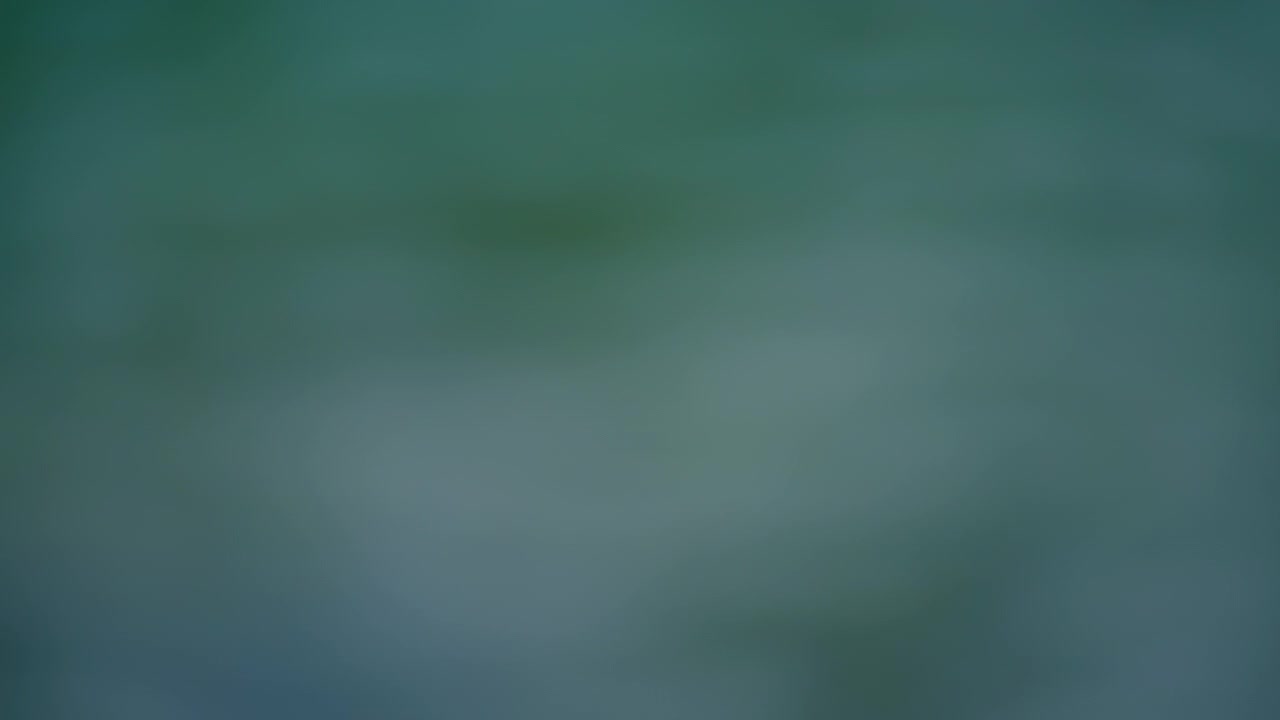 Abstract bokeh sunlight shining on a surface of turquoise lake