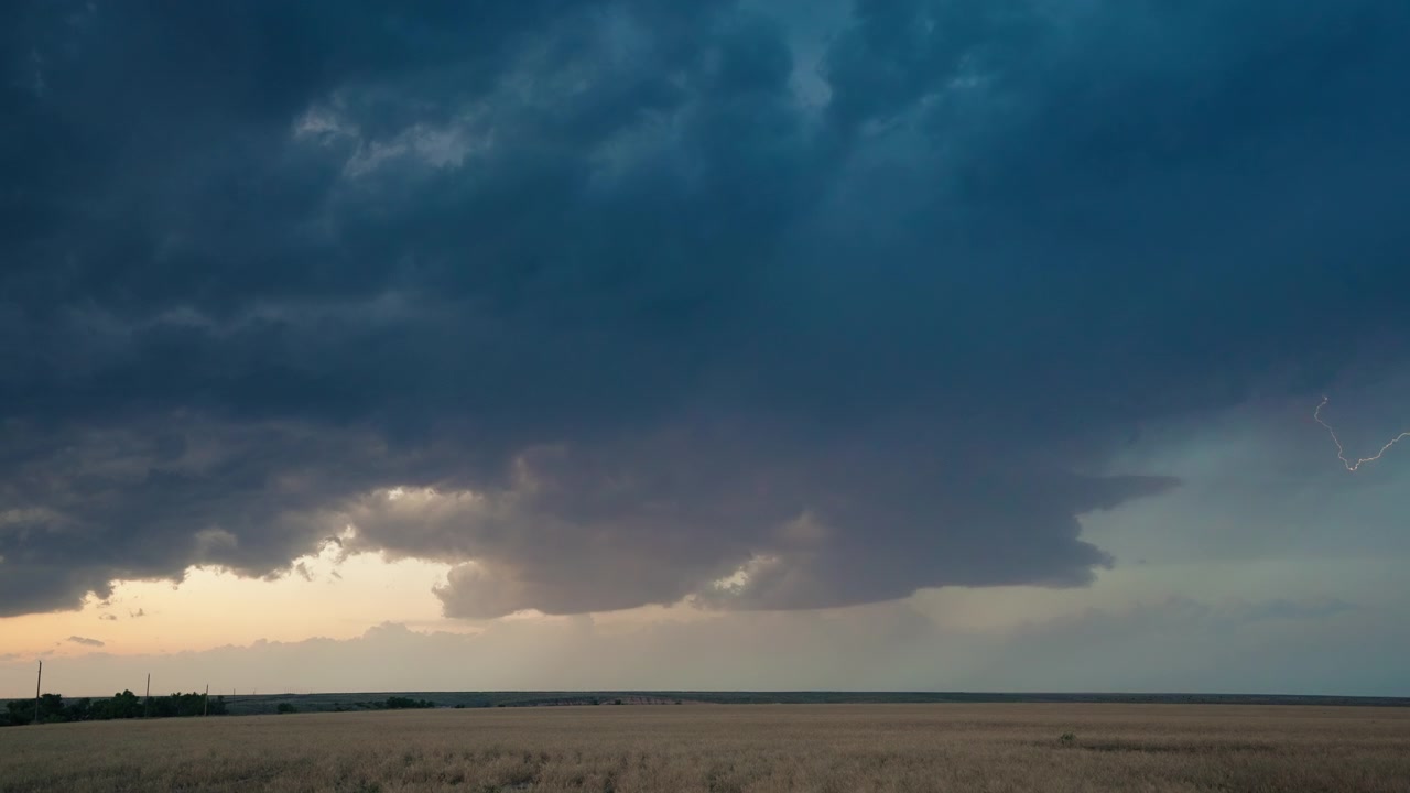 Flickering lightning across beautiful stormy sunset sky in stunning 4K