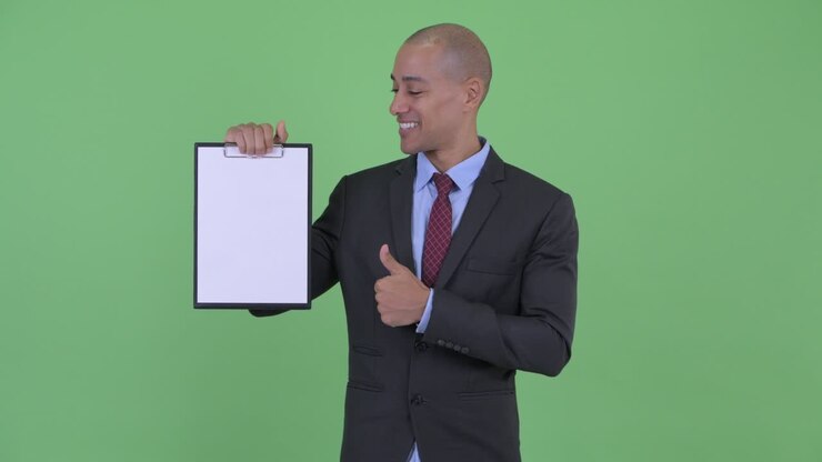 Happy handsome bald multi ethnic businessman with clipboard
