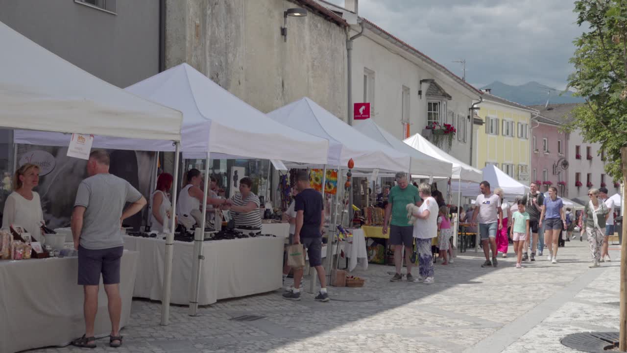 People shopping at a busy outdoor street market