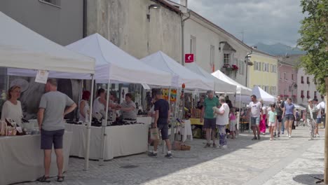 people shopping at a busy outdoor street market