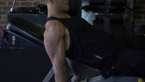 Tattoo-man-muscles-in-home-gym-doing-bicep-curls