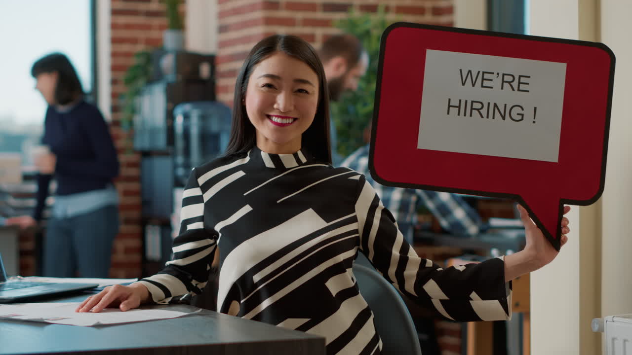 Portrait of business woman holding speech bubble to show job offer