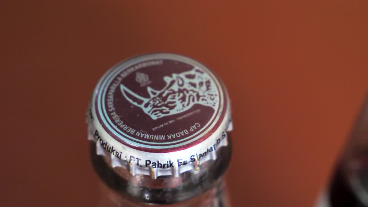 Slow motion shot of traditional Indonesian Badak glass bottles in a restaurant, close-up shot.