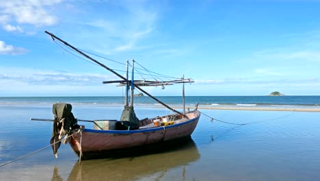 4k crane shot,fishing boats are parked on the beach with blue waters and blue skies on tropical landscapes.