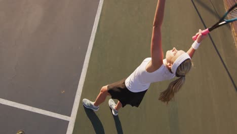 Video-of-top-view-of-caucasian-female-tennis-player-holding-racket-and-hitting-ball