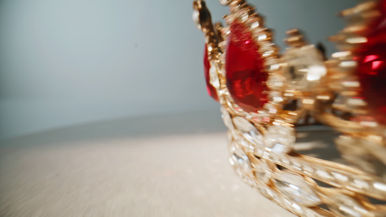 Closeup gemstones shining crown. Rich ornamented jewelry rotating indoors
