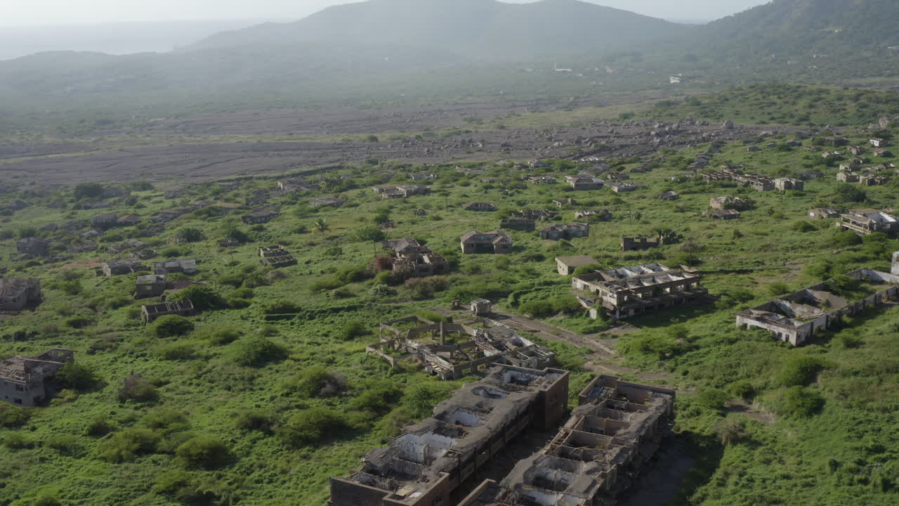 Smooth orbit above a long destroyed city. Mother nature reclaiming its land upon a volcanic Caribbean island.  Part_1