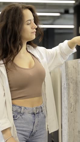 woman choosing tiles in a showroom