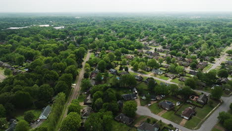 a neighborhood in collierville, suburb of memphis, tennessee, lush greenery surrounding cozy homes, aerial view