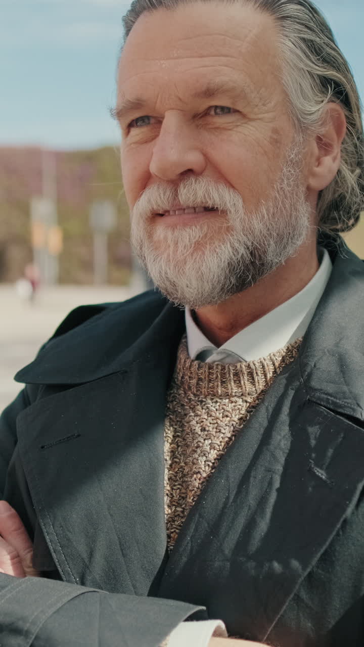Stylish Senior Man Smiles at City Bus Stop