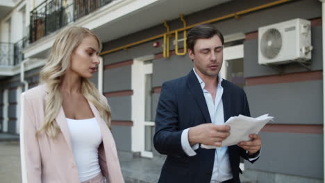 Close-up-view-of-couple-discussing-project-on-the-street