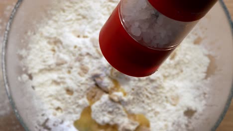 grinding salt in dough close up slow motion