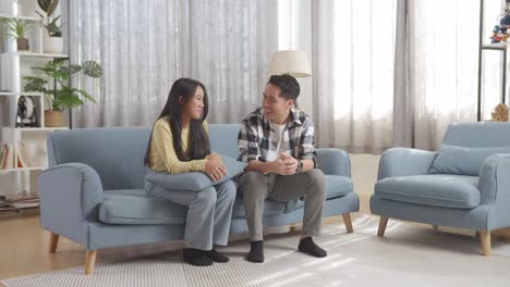 father and daughter talking on sofa