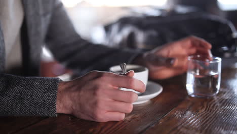 having a cup of coffee after a good session of yoga with my black bag on the table - close up