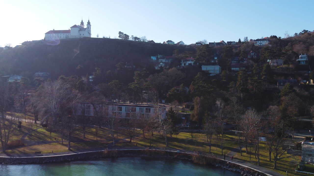 Wide drone shot of Tihany Monastery and adjacent hillside village by Lake Balaton in Hungary