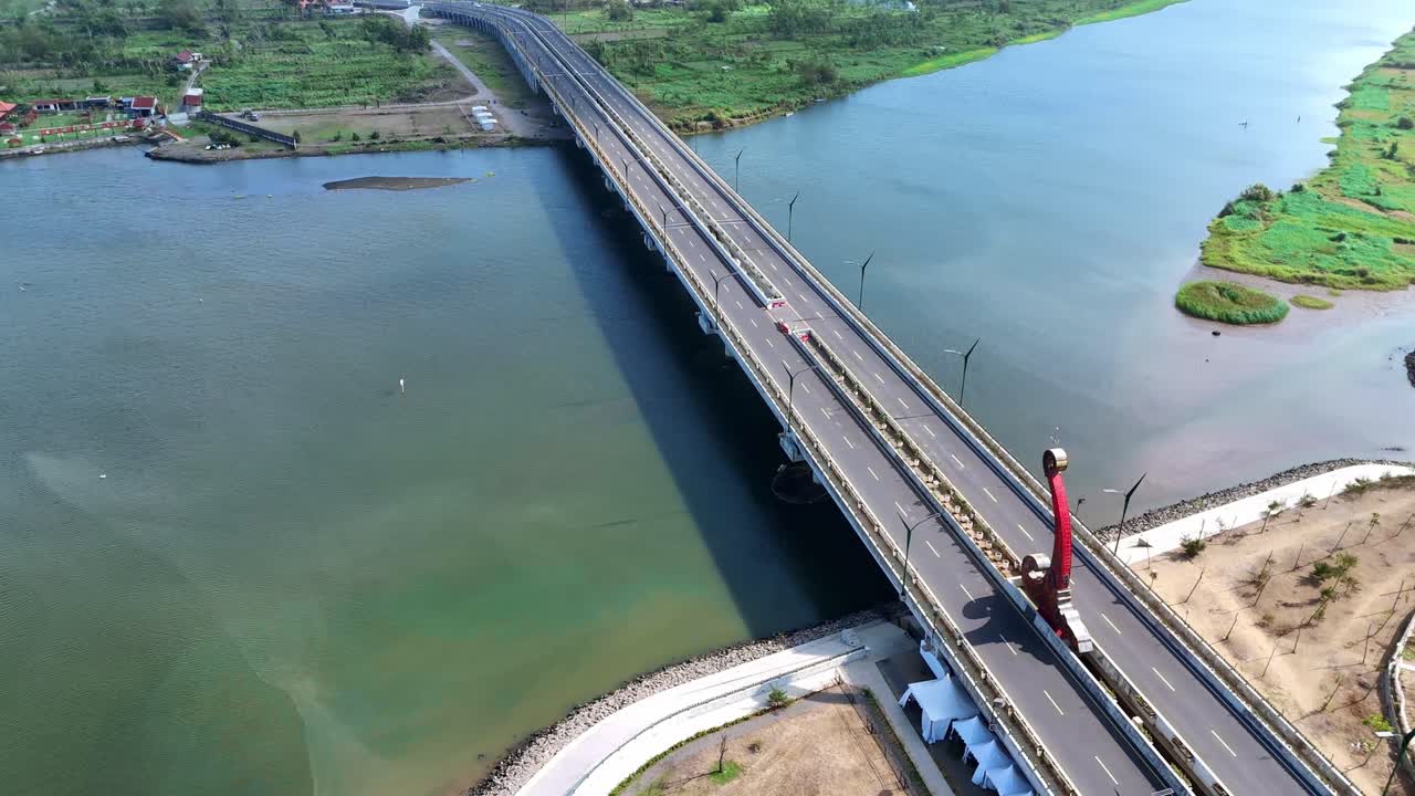 Aerial View of a Long Bridge Over a River in Indonesia