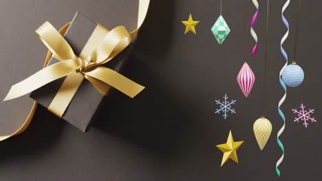 Animation-of-party-streamers-and-christmas-present-and-decorations