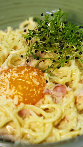 tasty appetizer in a plate. chef decorating delicious dish with green sprouts. healthy food. preparation of food in a restaurant. vertical video