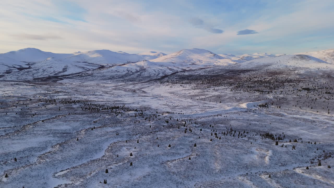 Stunning aerial view near Fish Lake, Whitehorse. Snowy Canadian landscapes with frosty mountains showcase Yukon’s untouched beauty in winter.