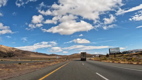 driving along a highway through the mojave desert towards the tehachapi mountains