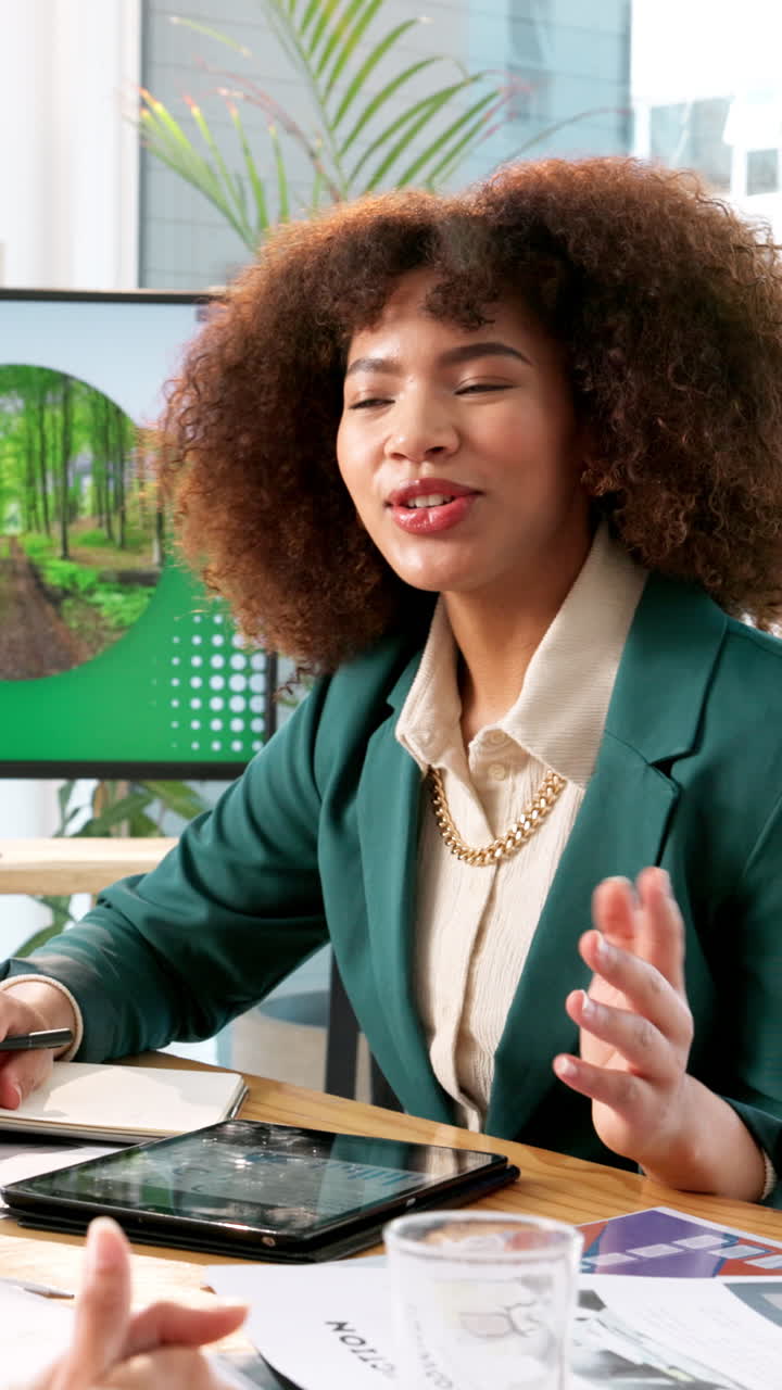 Young Businesswoman Speaking and Gesturing During an Office Meeting