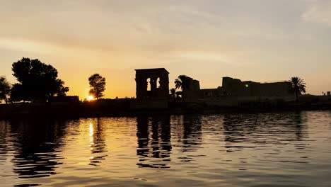 beautiful isis philae temple at sunset light the beautiful temple of philae and the greco-roman buildings are seen from the nile river a temple dedicated to isis, goddess of love aswan egyptian