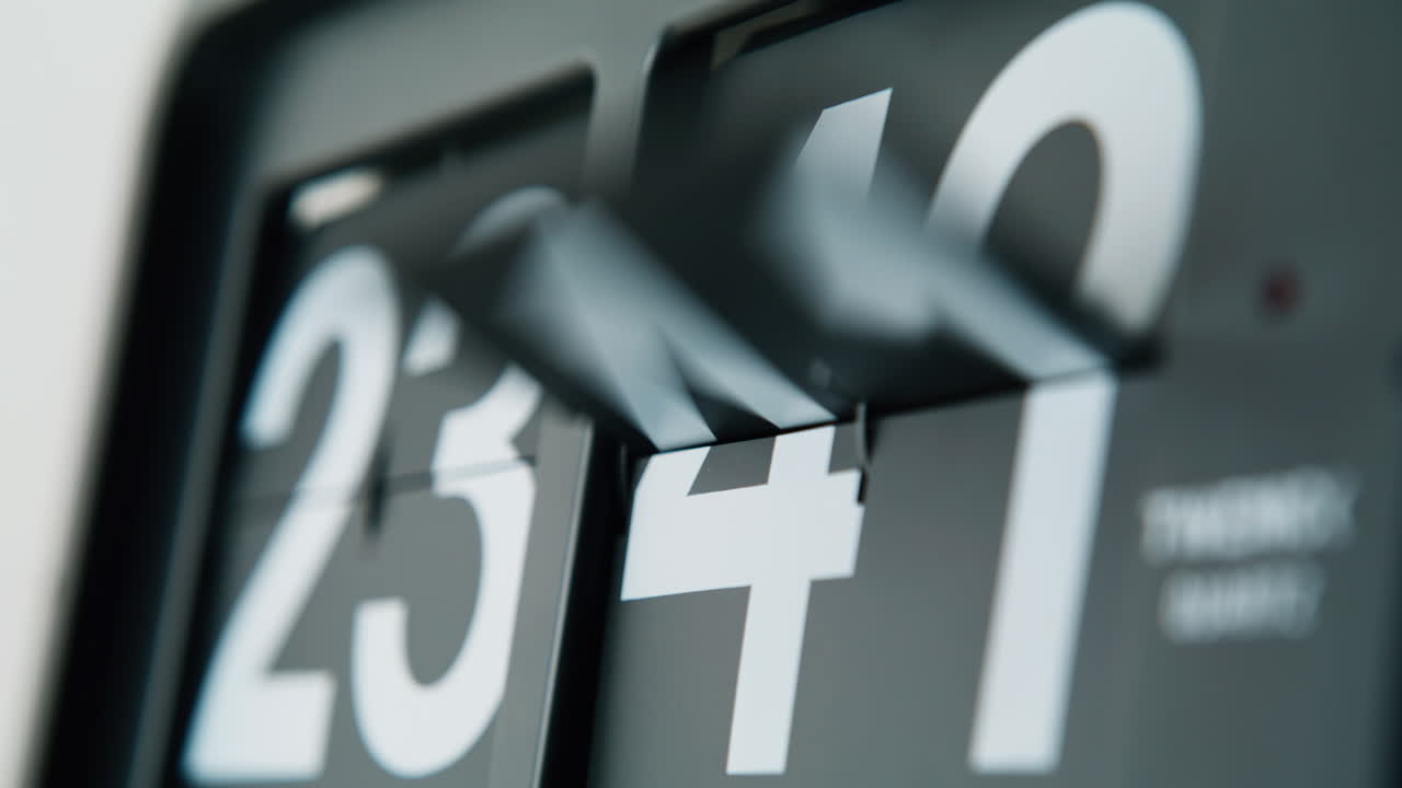 Flip clock rotating digits showing time flowing closeup. Black white panels