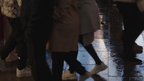 The-wet-London-streets-reflect-the-glowing-billboards-above-as-people-pass-by