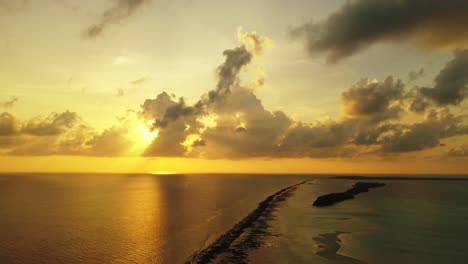 open-ocean-at-sunset,-dramatic-heavy-clouds-above-the-calm-seawater